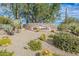 Community entrance showcases stone monument sign set amidst desert landscaping and mature trees at 7438 E Visao Dr, Scottsdale, AZ 85266
