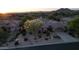 Charming desert home with a tile roof, beautiful desert landscaping, and stunning mountain views at sunset at 7438 E Visao Dr, Scottsdale, AZ 85266