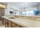 Kitchen showcasing stone countertops, stainless steel sink, stylish backsplash, and open access to the dining area at 7438 E Visao Dr, Scottsdale, AZ 85266