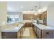 Spacious kitchen features wooden cabinets, stone countertops, and modern lighting at 7438 E Visao Dr, Scottsdale, AZ 85266
