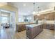 Open-concept kitchen with island, marble countertops, pendant lighting, and stainless steel appliances at 7438 E Visao Dr, Scottsdale, AZ 85266