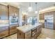 Gourmet kitchen boasting an island, marble countertops, built-in oven, and stainless steel refrigerator at 7438 E Visao Dr, Scottsdale, AZ 85266
