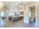 Spacious kitchen with a central island, wooden cabinets, and modern lighting at 7438 E Visao Dr, Scottsdale, AZ 85266