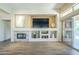 Stylish living room with a fireplace, built-in media center, and access to the outdoors at 7438 E Visao Dr, Scottsdale, AZ 85266