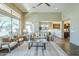 Open living room with high ceilings, large windows, and view into kitchen and back yard at 7438 E Visao Dr, Scottsdale, AZ 85266