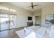 Bright main bedroom features wood floors, ceiling fan, and sliding door access to the outdoor space at 7438 E Visao Dr, Scottsdale, AZ 85266