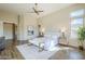 Main bedroom with a ceiling fan, accent art, and a sitting area with bench at 7438 E Visao Dr, Scottsdale, AZ 85266