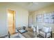 Office with a desk, chairs and open door leading to a bathroom at 7438 E Visao Dr, Scottsdale, AZ 85266