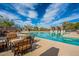 Resort-style community pool with lounge seating, clear blue water, and desert landscaping at 7438 E Visao Dr, Scottsdale, AZ 85266