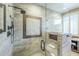 Walk-in shower features gorgeous decorative tilework, a built-in bench and a shower head at 7438 E Visao Dr, Scottsdale, AZ 85266