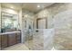 Walk in shower features marble style tiling, dual shower heads, and glass surround at 7438 E Visao Dr, Scottsdale, AZ 85266