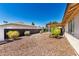 Backyard featuring decorative rock and desert landscaping with a covered patio at 8157 W Mclellan Rd, Glendale, AZ 85303