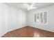 Clean, bright bedroom with wood floors and a window with white shutters at 8157 W Mclellan Rd, Glendale, AZ 85303