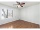 Bright bedroom featuring wood floors and a window with white shutters at 8157 W Mclellan Rd, Glendale, AZ 85303