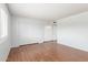Minimalist bedroom features double closets, wood flooring, and a bright, neutral color scheme at 8157 W Mclellan Rd, Glendale, AZ 85303