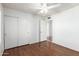 Neutral bedroom with wood floors, closet and ceiling fan at 8157 W Mclellan Rd, Glendale, AZ 85303