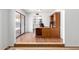 Bright home office features a classic wooden desk, hardwood floors, and sliding doors to the backyard at 8157 W Mclellan Rd, Glendale, AZ 85303