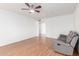 Neutral living room featuring a wood floor and ceiling fan at 8157 W Mclellan Rd, Glendale, AZ 85303
