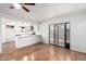 Open living space with view of kitchen and outdoor area, features hardwood floors and natural light at 8157 W Mclellan Rd, Glendale, AZ 85303
