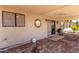 This covered patio has brick floors and is perfect for enjoying the outdoors with ceiling fan at 8157 W Mclellan Rd, Glendale, AZ 85303