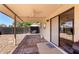 Covered outdoor patio with brick flooring, ceiling fan, and sliding glass door at 8157 W Mclellan Rd, Glendale, AZ 85303