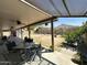 Large covered back patio features an outdoor dining table and plenty of shade at 9001 W Windsor Ave, Phoenix, AZ 85037