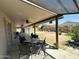 Large covered back patio features an outdoor dining table and plenty of shade at 9001 W Windsor Ave, Phoenix, AZ 85037