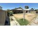 View of spacious backyard with covered patio, showing potential for landscaping at 9001 W Windsor Ave, Phoenix, AZ 85037