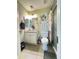 Bright bathroom with a single sink vanity, decorative mirror, and a glass-enclosed shower at 9001 W Windsor Ave, Phoenix, AZ 85037