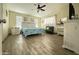 A charming bedroom with a ceiling fan, neutral walls, and plenty of natural light at 9001 W Windsor Ave, Phoenix, AZ 85037