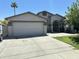 Charming single-story home featuring a spacious driveway, two-car garage, desert landscaping and a well-maintained lawn at 9001 W Windsor Ave, Phoenix, AZ 85037