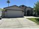 Charming single-story home featuring a spacious driveway, two-car garage, desert landscaping and a well-maintained lawn at 9001 W Windsor Ave, Phoenix, AZ 85037