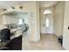 Bright foyer featuring tile floors, a white front door with glass insert, and archway through to the kitchen at 9001 W Windsor Ave, Phoenix, AZ 85037