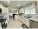 Charming kitchen with granite countertops, stainless appliances, white cabinets, and tile flooring at 9001 W Windsor Ave, Phoenix, AZ 85037