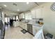 Beautiful kitchen with granite counters, stainless appliances, white cabinetry, and open floor plan at 9001 W Windsor Ave, Phoenix, AZ 85037