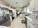 Spacious kitchen features stainless steel appliances, granite counters, white cabinets, and tile flooring at 9001 W Windsor Ave, Phoenix, AZ 85037