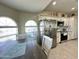 Kitchen/Dining Room combo with arched windows, granite countertops, and stainless steel appliances at 9001 W Windsor Ave, Phoenix, AZ 85037