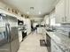 Spacious kitchen with stainless steel appliances, granite counters, white cabinets, and tile flooring at 9001 W Windsor Ave, Phoenix, AZ 85037