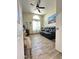 Cozy living room with tile floors, a large window, and a comfortable leather couch at 9001 W Windsor Ave, Phoenix, AZ 85037