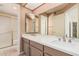This bathroom features double sinks with a large mirror and a shower with a glass door at 9151 W Greenway Rd # 212, Peoria, AZ 85381