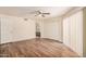 This bedroom features wood floors, a ceiling fan, closet, and a doorway to the bathroom at 9151 W Greenway Rd # 212, Peoria, AZ 85381