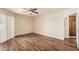 This bedroom features wood floors, a ceiling fan, and a doorway into another room at 9151 W Greenway Rd # 212, Peoria, AZ 85381
