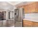 Kitchen view featuring stainless steel refrigerator, wood cabinets, and white countertops at 9151 W Greenway Rd # 212, Peoria, AZ 85381