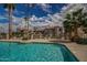 Community pool view features sparkling water, lounge chairs, and lush landscaping at 9151 W Greenway Rd # 212, Peoria, AZ 85381