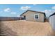 Exterior view of the home showcasing a spacious yard with block fence and covered patio at 9533 W Luxton Ln, Tolleson, AZ 85353