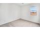 Bright bedroom showcases neutral carpet, window with a view, base trim, and electrical outlets at 9533 W Luxton Ln, Tolleson, AZ 85353