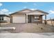 Charming single-story house showcasing a two car garage, desert landscaping, and welcoming front porch at 9533 W Luxton Ln, Tolleson, AZ 85353
