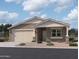 Beautiful single-story home featuring a two car garage, neutral stucco, and a low maintenance front yard at 9533 W Luxton Ln, Tolleson, AZ 85353