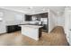 Contemporary kitchen featuring dark cabinetry, stainless steel appliances, and a white countertop island at 9533 W Luxton Ln, Tolleson, AZ 85353
