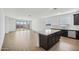 Spacious kitchen island with stainless steel appliances, tiled backsplash, and dark cabinets at 9533 W Luxton Ln, Tolleson, AZ 85353